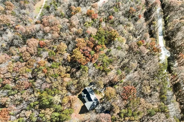 a view of a house with a small yard and wooden fence