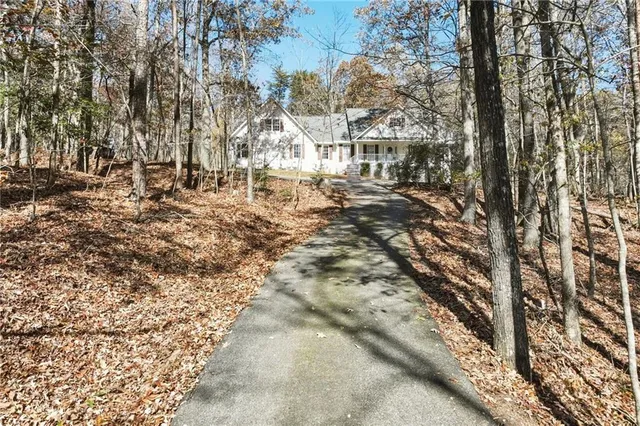 a view of a house with backyard sitting area and garden