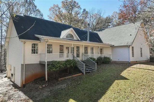 a view of a porch with wooden floor and fence