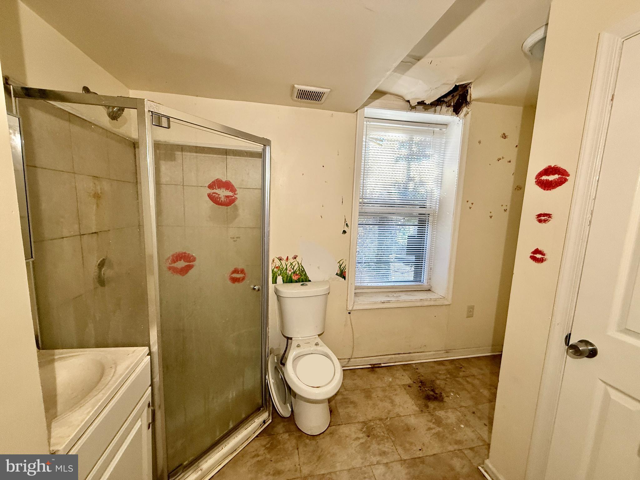 340 South Calhoun Street Baltimore, MD 21223 - Photo 12 of 15 a bathroom with a granite countertop shower sink and mirror