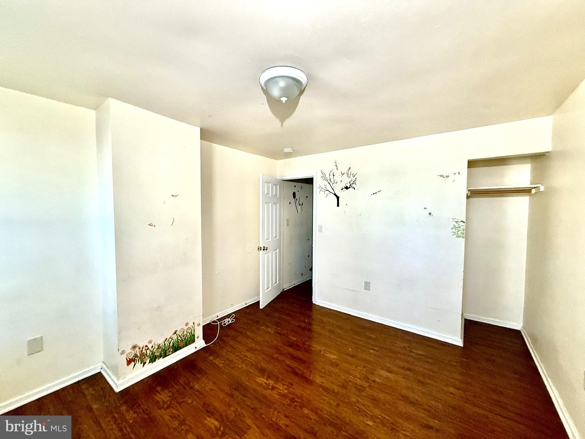 340 South Calhoun Street Baltimore, MD 21223 - Photo 7 of 15 a view of an empty room with wooden floor