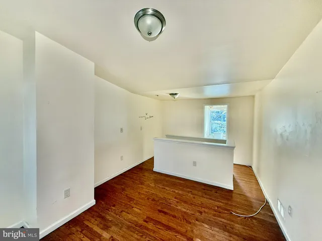 a bathroom with a granite countertop shower sink and mirror