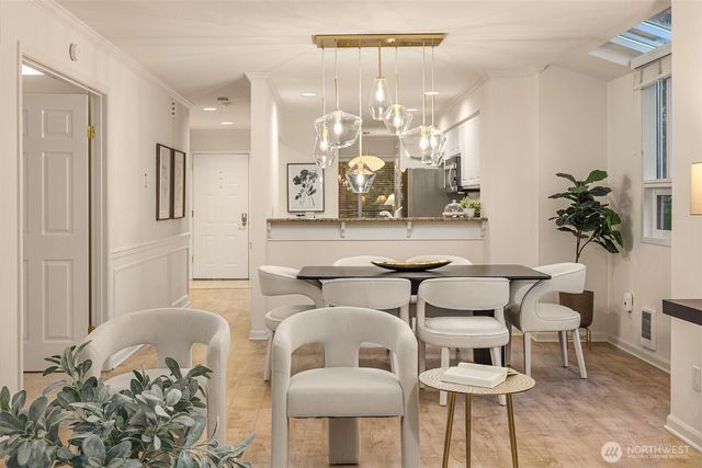 a view of a dining room with furniture and chandelier