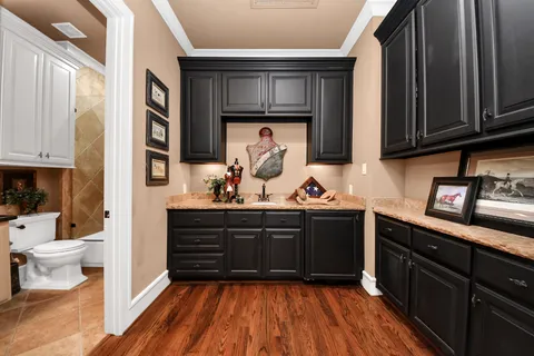 a kitchen with wooden floors and sink
