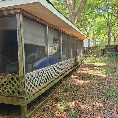 a view of backyard with wooden fence