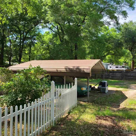 a view of a garden with wooden fence