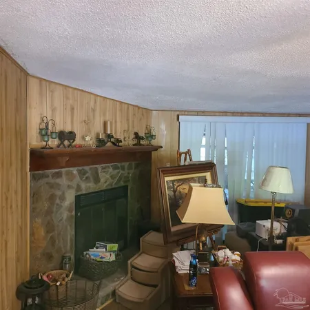 a living room with furniture a lamp and a fireplace