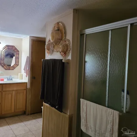 a bathroom with a shower and a sink