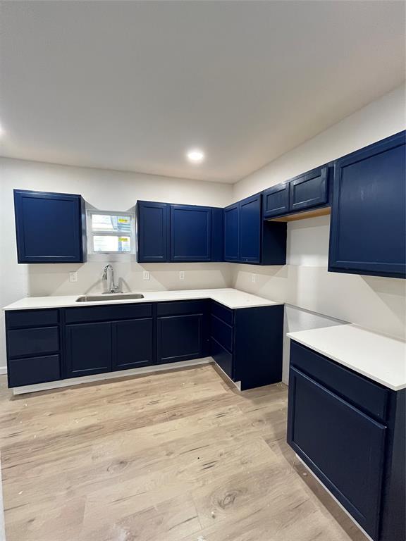3919 Carl Street Dallas, TX 75210 - Photo 11 of 17 a kitchen with stainless steel appliances kitchen island granite countertop wooden cabinets and sink