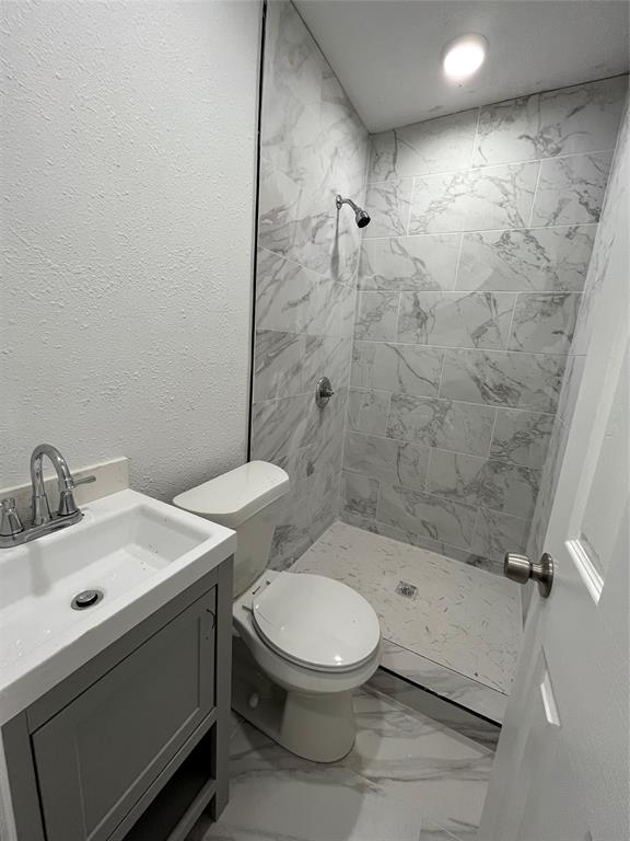 3919 Carl Street Dallas, TX 75210 - Photo 13 of 17 a bathroom with a sink a toilet and shower