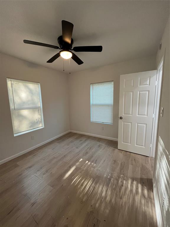 3919 Carl Street Dallas, TX 75210 - Photo 15 of 17 a view of empty room with wooden floor and fan