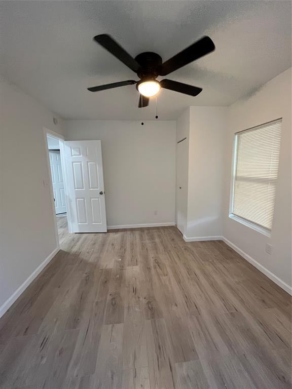 3919 Carl Street Dallas, TX 75210 - Photo 5 of 17 a view of empty room with wooden floor and fan