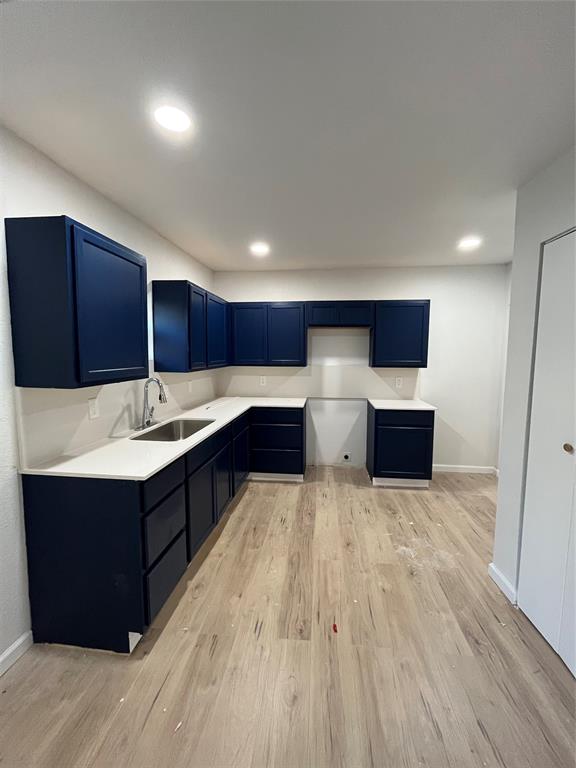 3919 Carl Street Dallas, TX 75210 - Photo 9 of 17 a kitchen with wooden cabinets and a sink