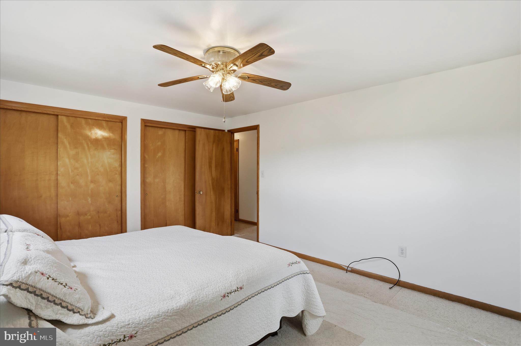199 Buser Street Ridgeley, WV 26753 - Photo 23 of 49 a bedroom with a bed and a chandelier