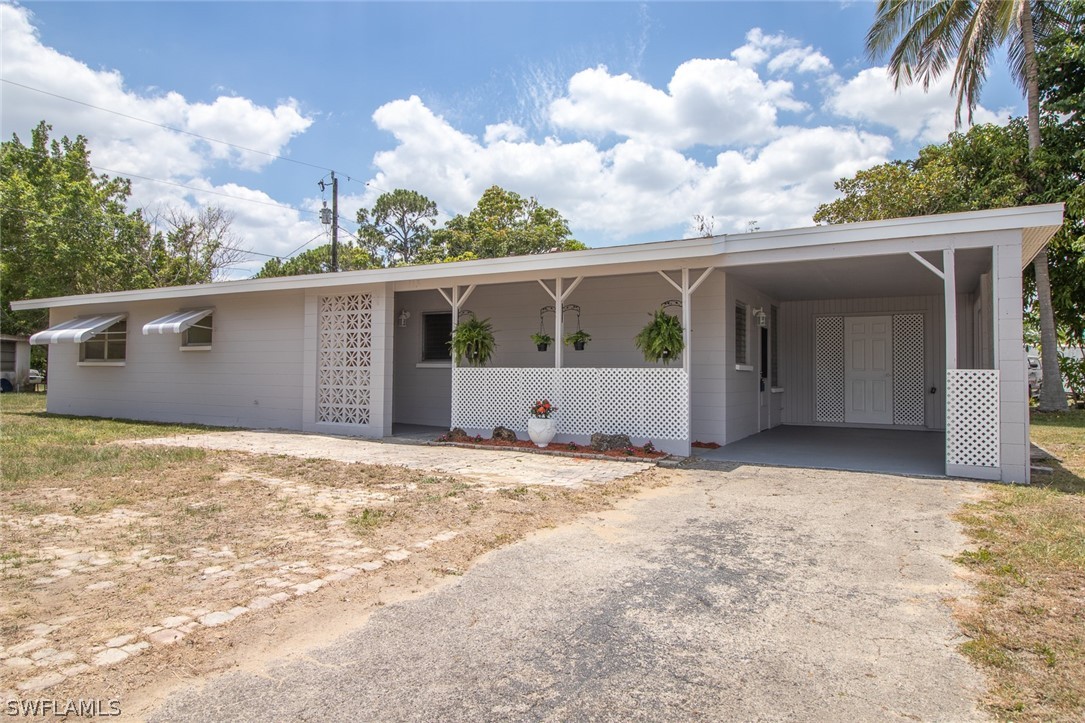 113 Oleander Road Lehigh Acres, FL 33936 - Photo 18 of 20 a view of an house with backyard and garden