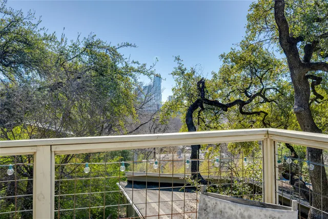 a roof deck with wooden floor and fence