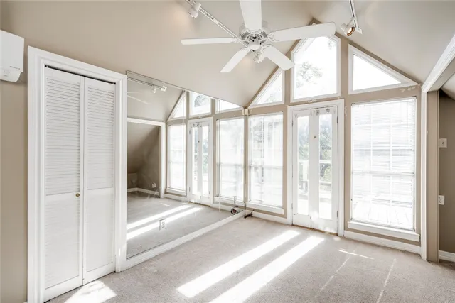a view of a livingroom with a ceiling fan and window
