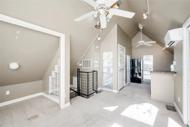 a view of a hallway with entryway and chandelier