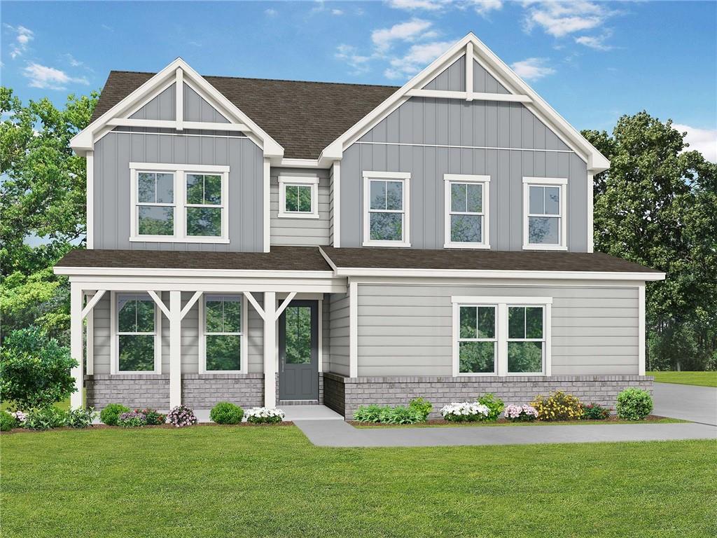 a front view of a house with a garden and plants