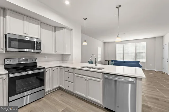 a kitchen with a stove sink and microwave