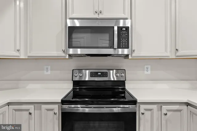 a stove top oven sitting inside of a kitchen