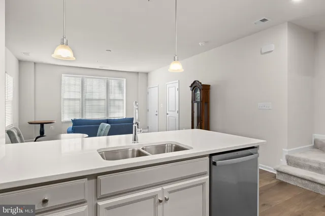 a kitchen with a sink and a refrigerator