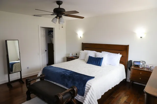a bedroom with a bed and a chandelier