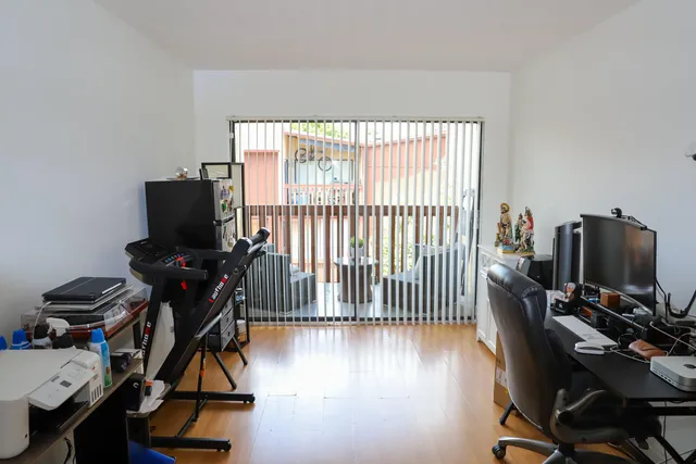a view of a workspace with furniture and a window
