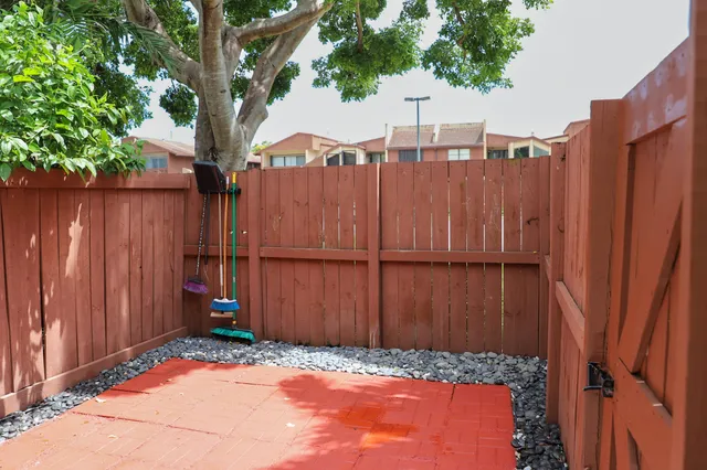 a view of patio with a table and chairs under an umbrella
