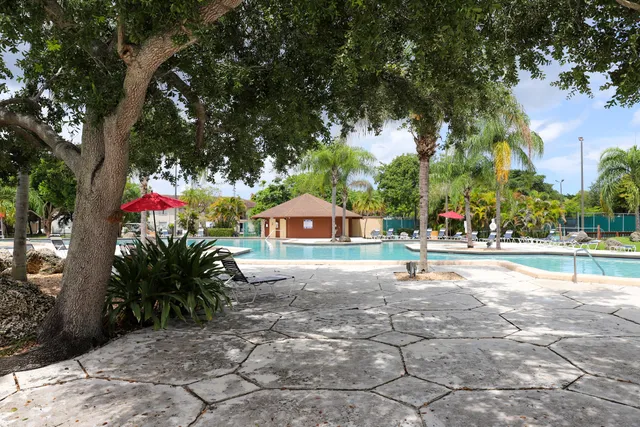 a view of swimming pool with outdoor seating and plants