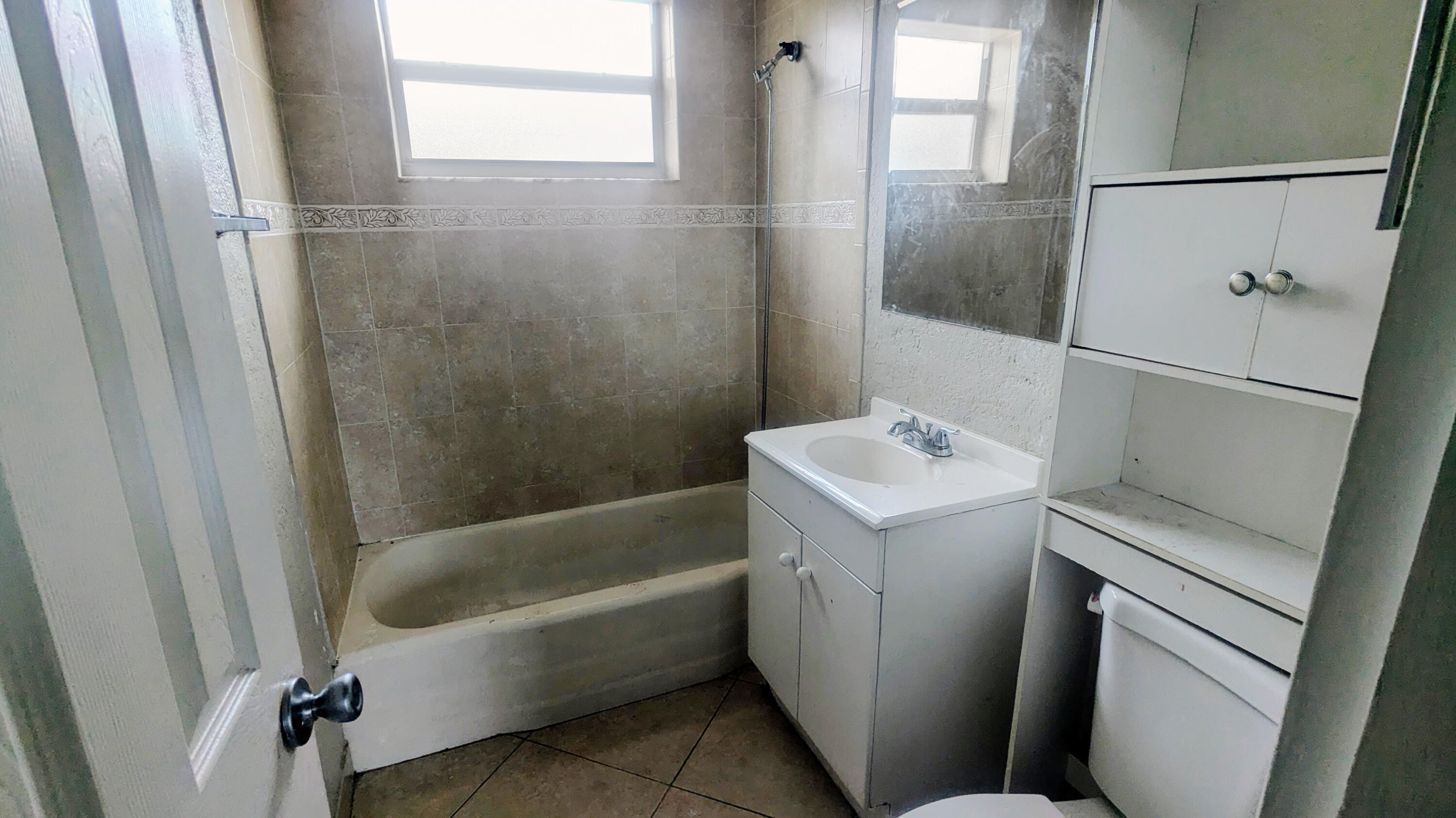 85 Morgans Way Palm Springs, FL 33461 - Photo 5 of 17 a bathroom with a sink a window and a shower