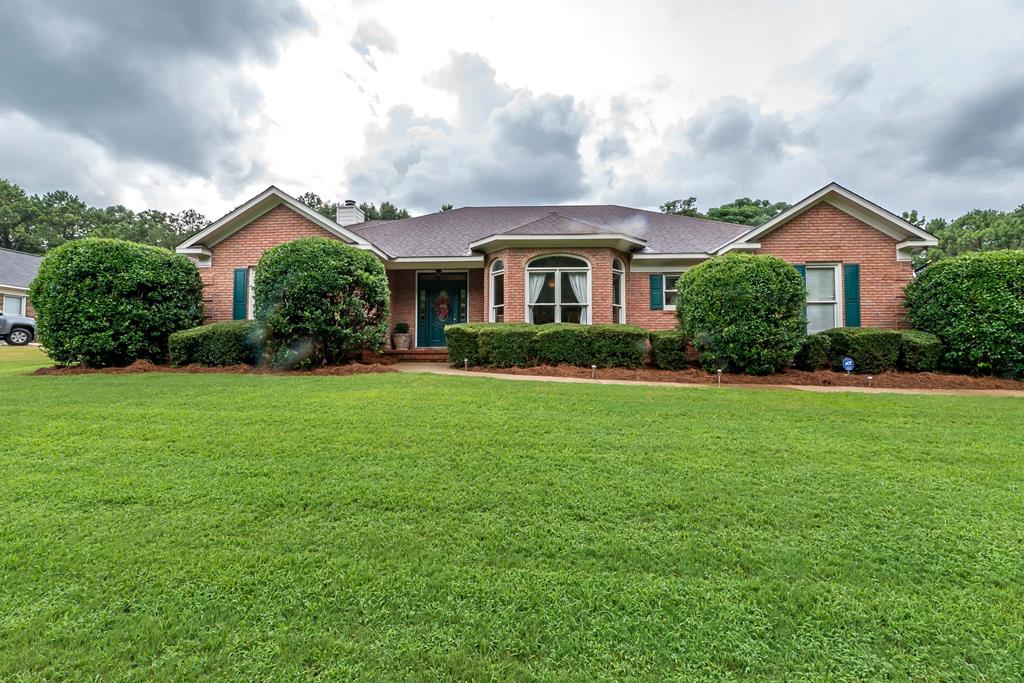 a front view of house with yard and green space