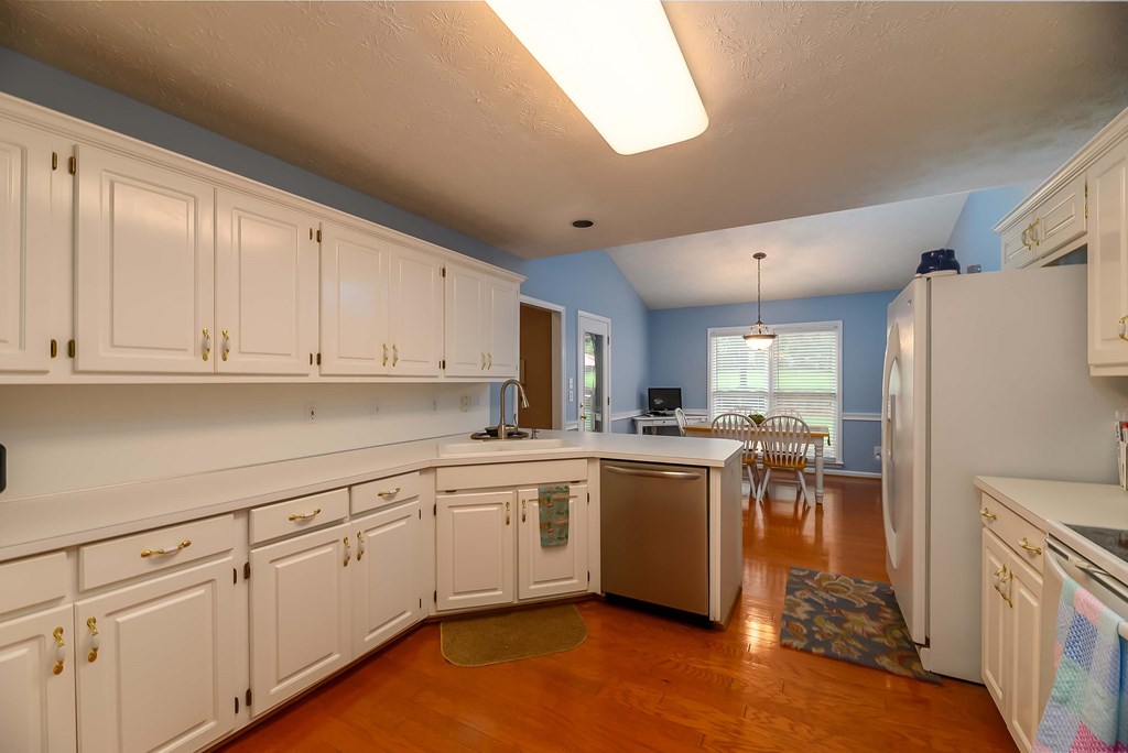 32 Bugle Brook Court Midland, GA 31820 - Photo 11 of 30 a kitchen with white cabinets and white appliances