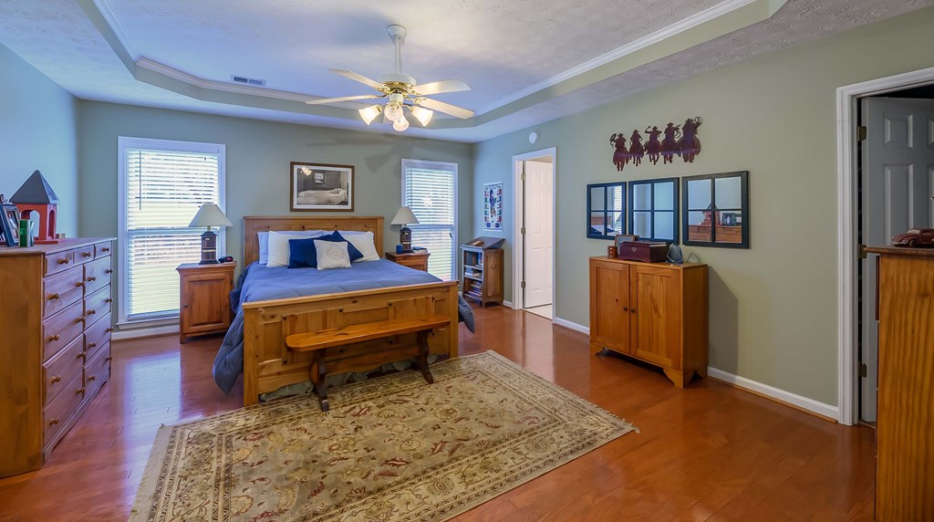 32 Bugle Brook Court Midland, GA 31820 - Photo 15 of 30 a bedroom with a bed furniture and a chandelier