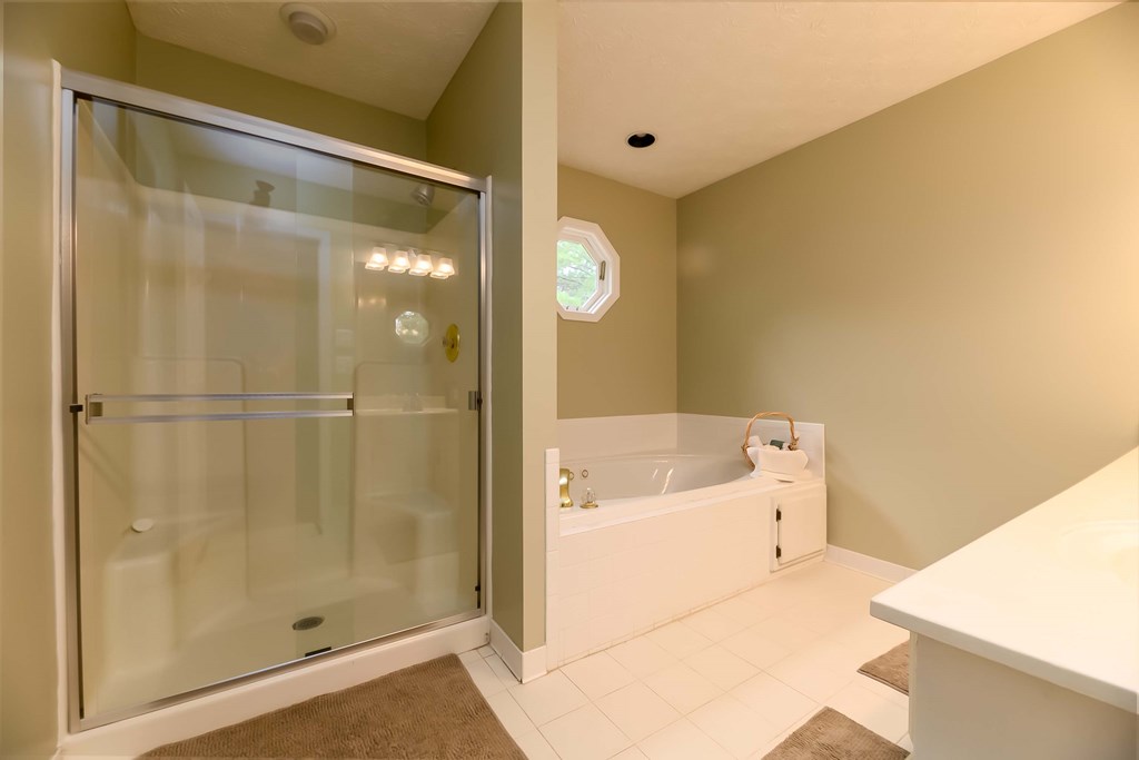 32 Bugle Brook Court Midland, GA 31820 - Photo 16 of 30 a bathroom with a bathtub and a shower