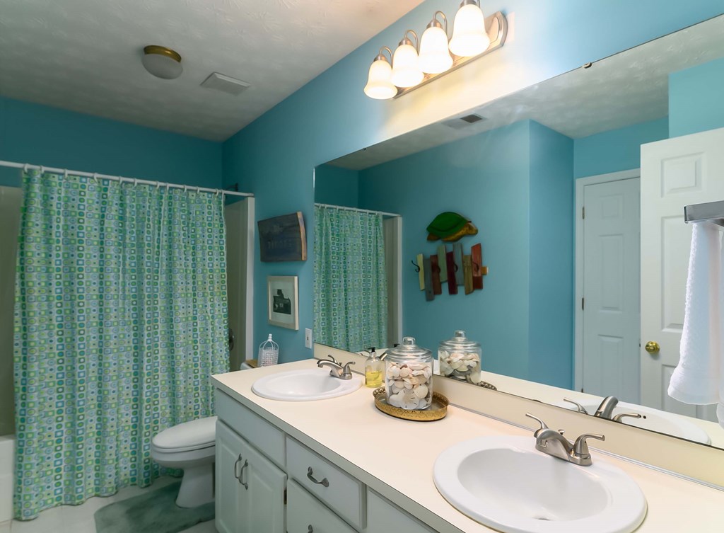 32 Bugle Brook Court Midland, GA 31820 - Photo 20 of 30 a bathroom with a double vanity sink toilet and a mirror
