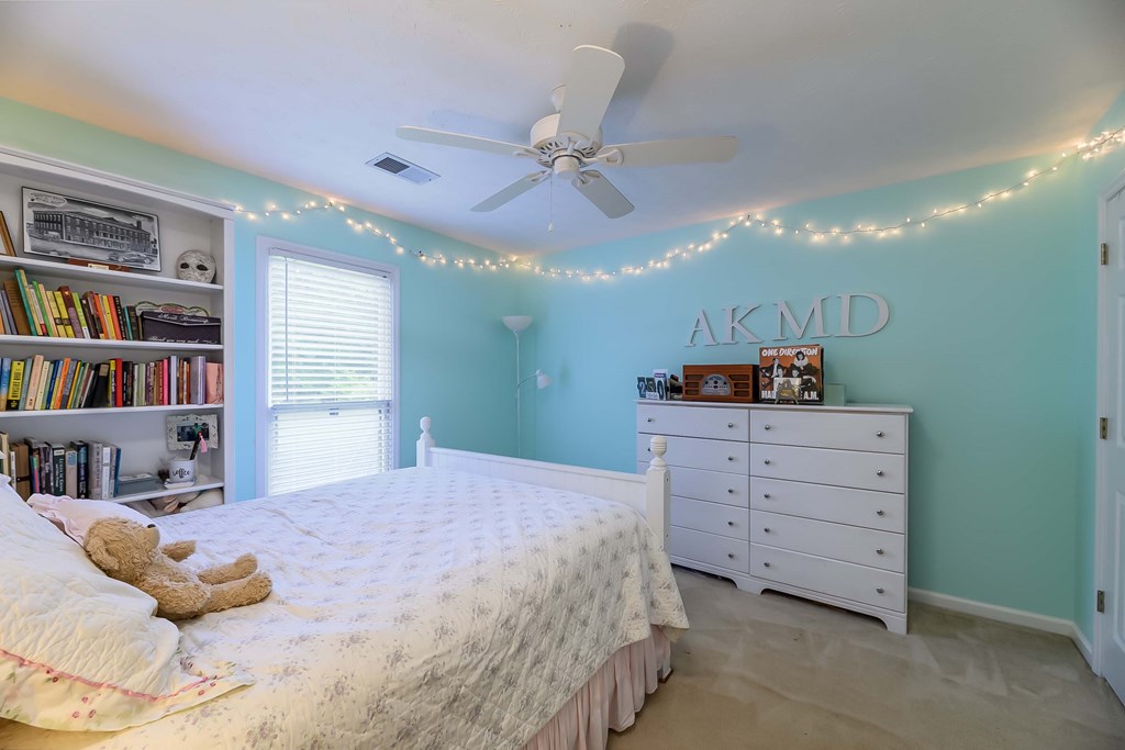 32 Bugle Brook Court Midland, GA 31820 - Photo 21 of 30 a bedroom with a bed and a book shelf