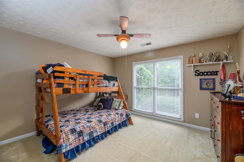 32 Bugle Brook Court Midland, GA 31820 - Photo 22 of 30 a bedroom with bed and a large window