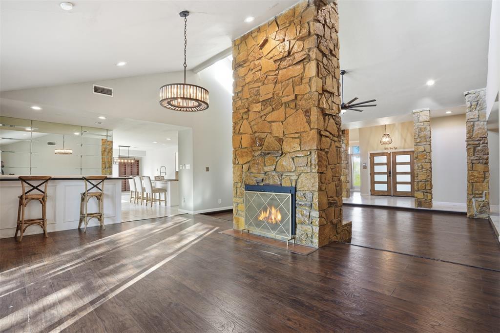 704 Timberview Court North Fort Worth, TX 76112 - Photo 12 of 40 a view of a room with lots of wooden furniture and a fireplace