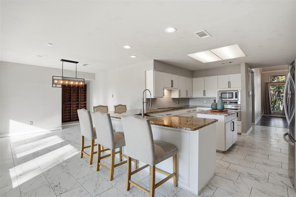 704 Timberview Court North Fort Worth, TX 76112 - Photo 16 of 40 a large kitchen with a table and chairs