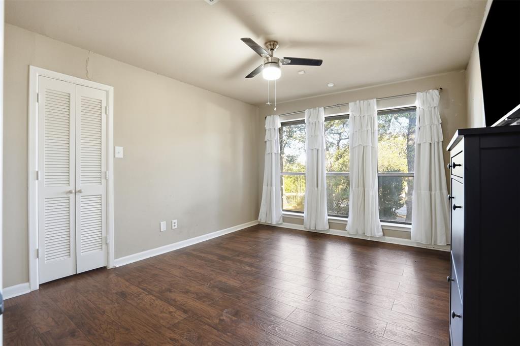 704 Timberview Court North Fort Worth, TX 76112 - Photo 24 of 40 a view of an empty room with a window and wooden floor
