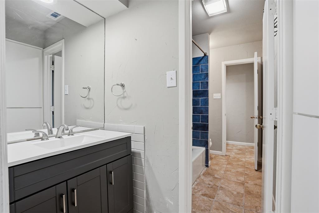 704 Timberview Court North Fort Worth, TX 76112 - Photo 25 of 40 a bathroom with a sink and a mirror
