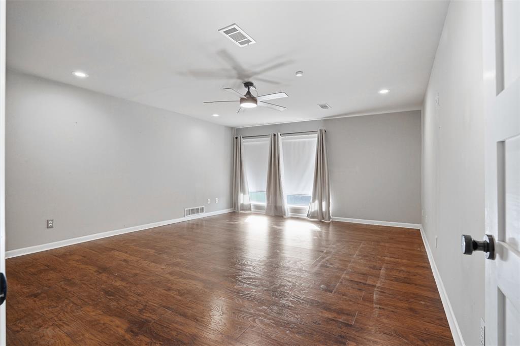 704 Timberview Court North Fort Worth, TX 76112 - Photo 28 of 40 wooden floor in an empty room with a window
