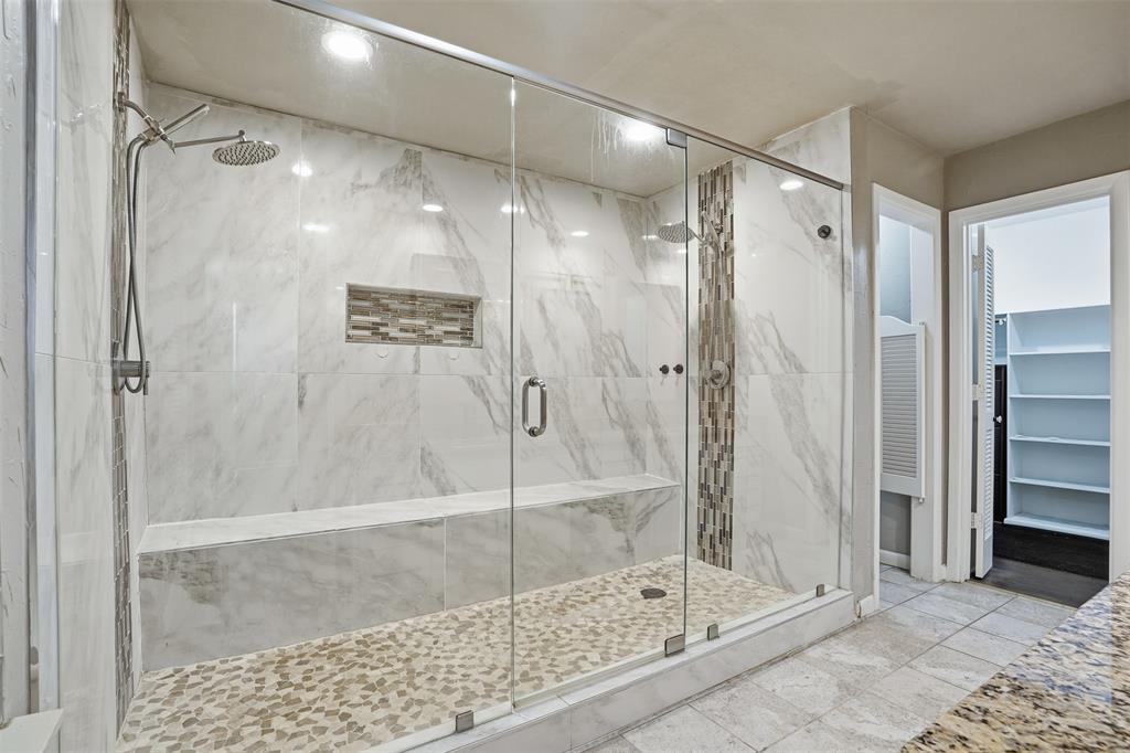 704 Timberview Court North Fort Worth, TX 76112 - Photo 30 of 40 a bathroom with a glass shower door