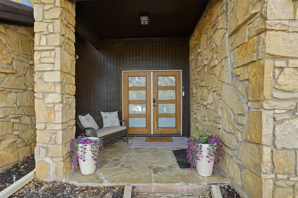 704 Timberview Court North Fort Worth, TX 76112 - Photo 4 of 40 a living room with a couch and a potted plant