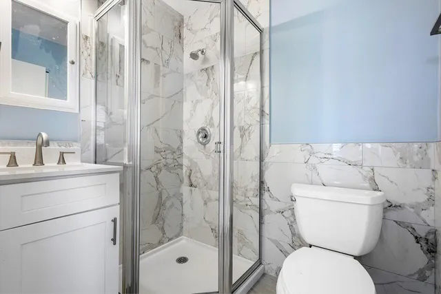 a bathroom with a toilet a sink and shower