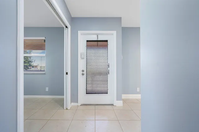 a view of an empty room with closet and a window