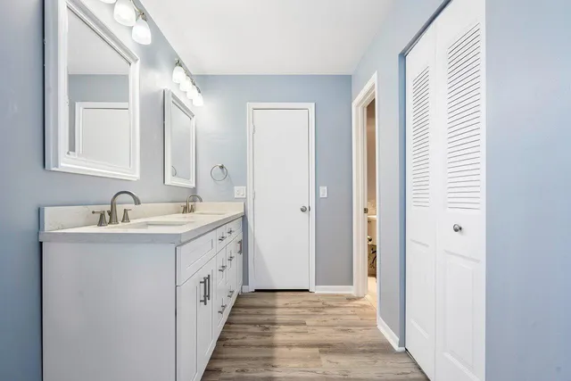 a bathroom with a double vanity sink and a mirror