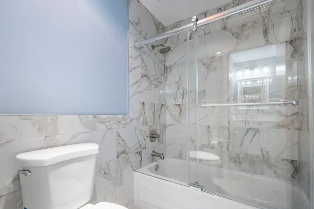 a bathroom with a bathtub and a toilet