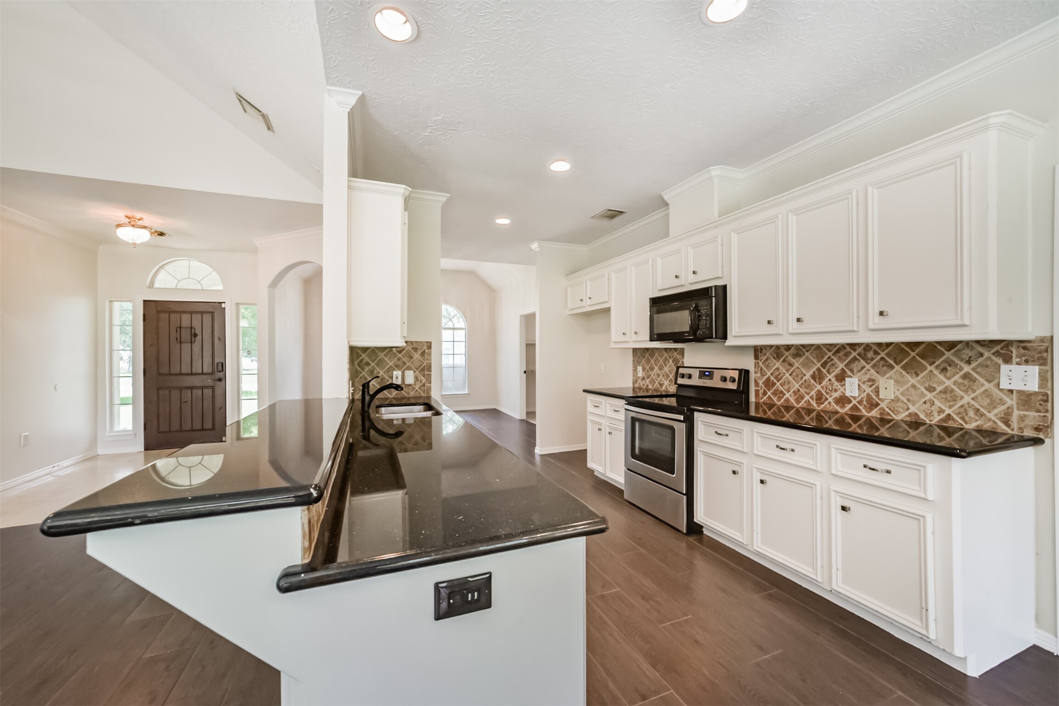27322 Afton Way Huffman, TX 77336 - Photo 17 of 50 Functional galley-style kitchen features ample prep space, recessed lighting, and an open layout overlooking the main living area.